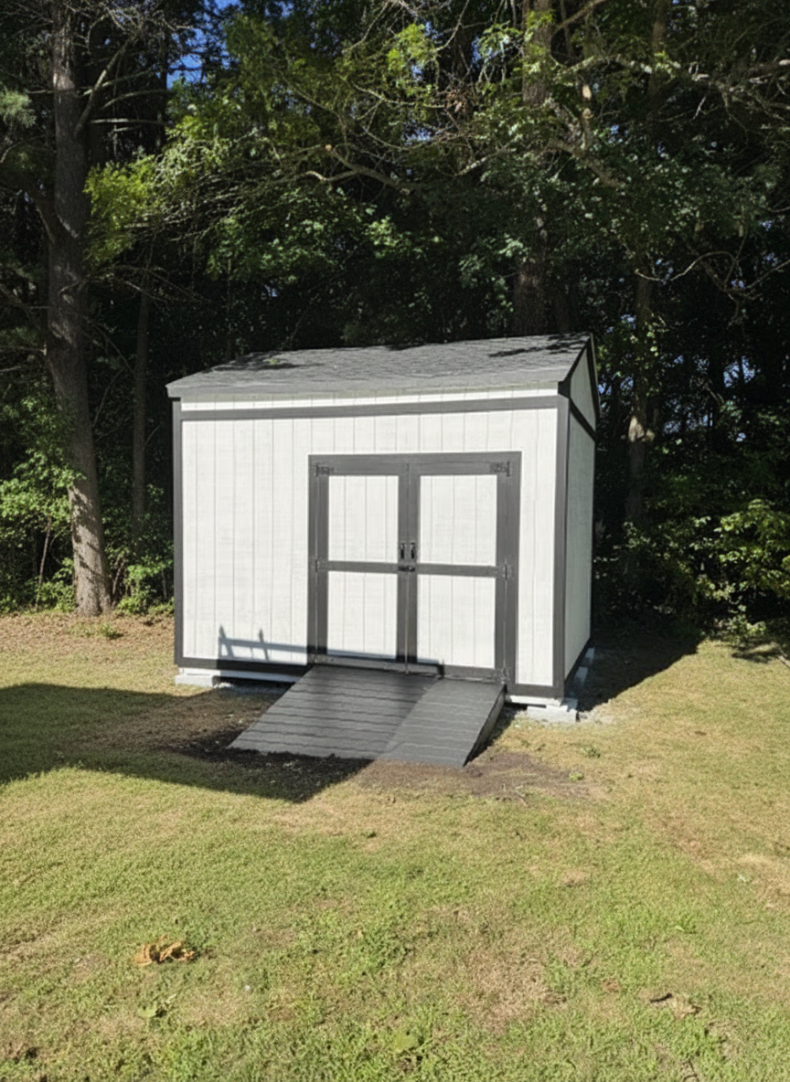 A newly repaired garden shed in Derry, NH with fresh siding and secure hinges on the door