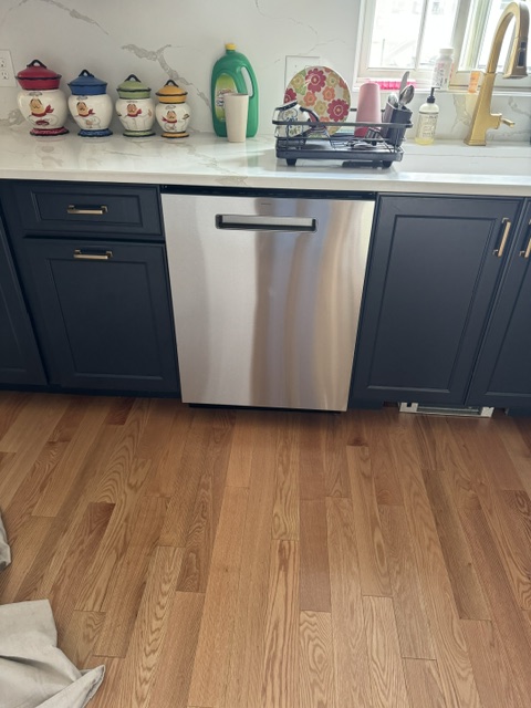 Kitchen with navy blue cabinets and stainless steel dishwasher